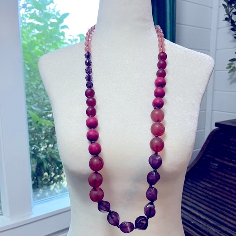 Reitman’s Costume jewelry long, adjustable, beaded necklace in pinks and purple